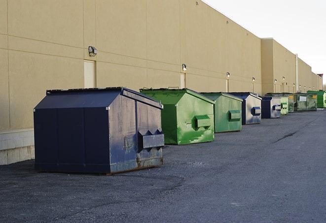 a pile of demolition waste sits beside a dumpster in a parking lot in Beverly Hills